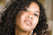 © TheVisualsYouNeed - lifestyle close up head portrait of young beautiful and sexy mixed ethnicity latin and African American woman with gorgeous curly hair in seductive face