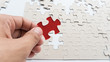 © prakasitlalao - Hand put missing jigsaw puzzle into the paper board
