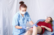 © finist_4 - A female beautician removes hair with sugar paste on his left knee a young woman in a red dress