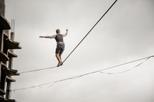 Young Active Man Walking On The Slackline Rope