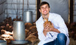 Portrait of cheerful man veterinarian with chicken