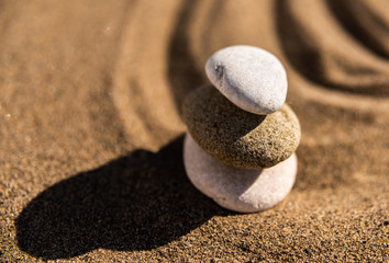 zen meditation stone in sand, concept for purity harmony and spirituality, spa wellness and yoga background