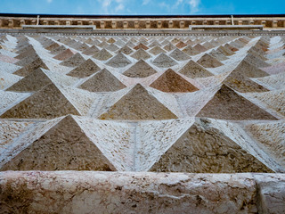 Diamand shaped marble stones on the facade of the Palazzo dei Diamanti in Ferrara, Italy