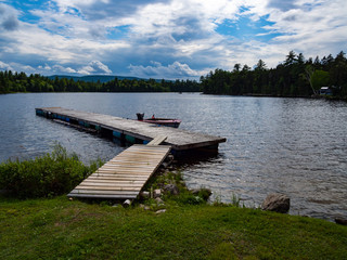 waterfront view from lawn, wooden dock on water
