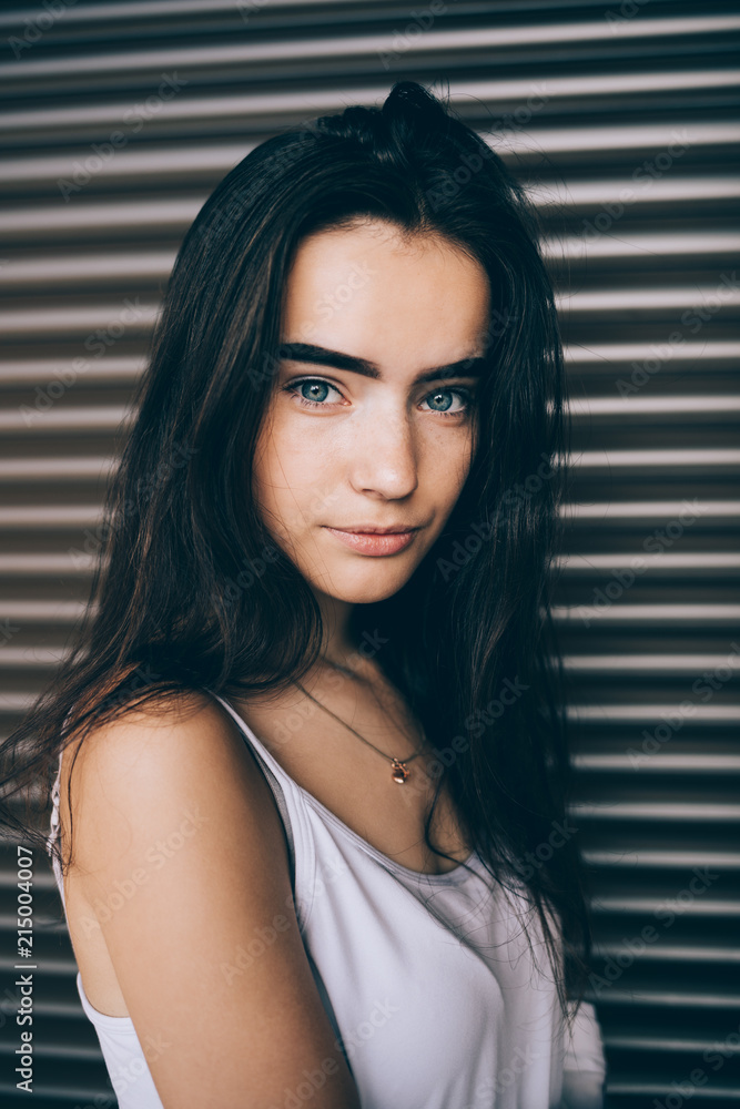 Portrait of cute girl with long dark hair and blue eyes Stock Photo ...