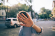 Beautiful young woman covering face with her palm