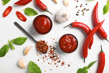 Flat Lay Composition With Bowls Of Hot Chili Sauce And Different Spices On Light Background