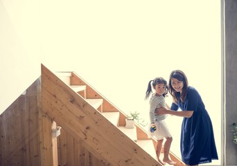 Wall Mural - Mother and daughter playing together