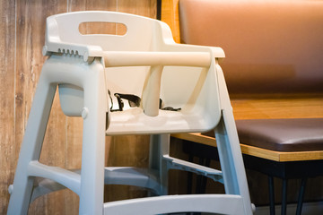 high chair seat for sit eating position for kids in fast food.use baby chair seat for safe cute child in cafe breakfast.high chair seat have guard for protect baby sitting.high chair seat position.