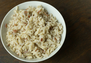 Canvas Print - A Cooked  Jasmine Rice , Brown Rice in bowl  on wood table.