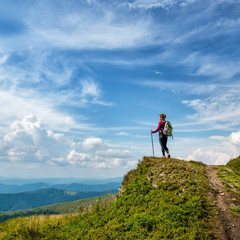 Wall Mural - young woman hiking in the mountains