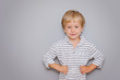 © natalia_4g - Cute three years old boy with blond hair on grey background with copy space