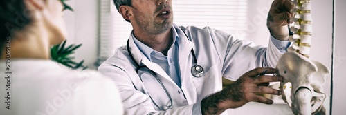Doctor showing woman part of spine Tableau sur Toile