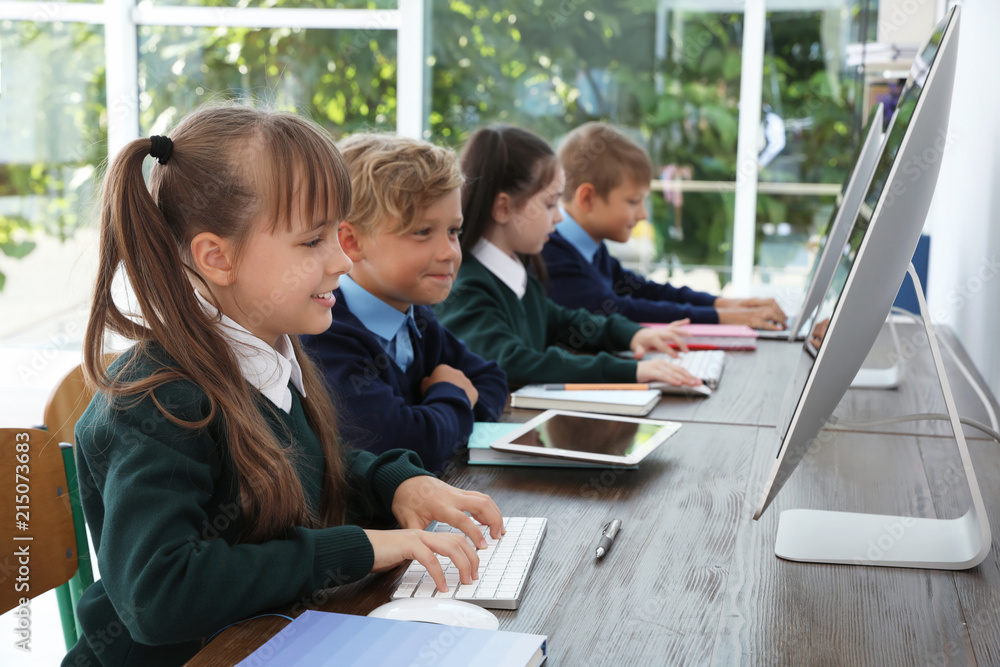 Foto de Stock Little children in stylish school uniform at desks with ...
