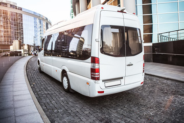 Wall Mural - white mini bus moves down the street