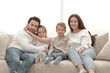 © ASDF - family sitting on the couch in the free evening.