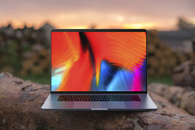 A laptop with a colorful screen on wooden beams. Laptop in focus. High detailed.