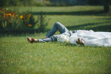 Wall Mural - Bride and Groom Laying on Grass