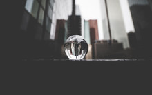 Glass Ball In The Middle Of A City With Skyscrapers, Moody