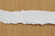 © naiauss - torn paper texture on wood background, copy space.