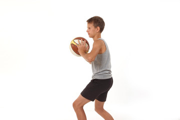 Wall Mural - teenager with a basketball on a white background.