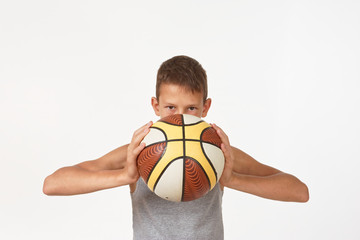 Wall Mural - teenager with a basketball on a white background.