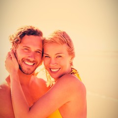 Wall Mural - Portrait of smiling couple embracing at beach