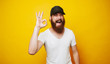 © Vulp - Young cheerful bearded man showing OK sign gesture