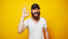 Young Cheerful Bearded Man Showing OK Sign Gesture