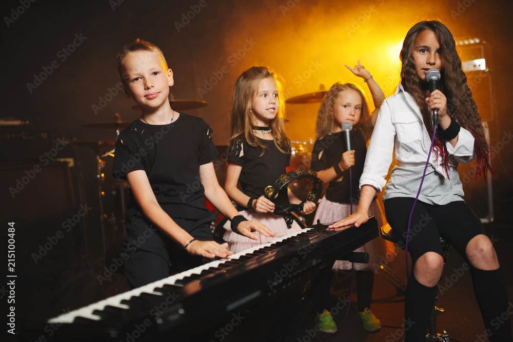 children singing and playing music in recording studio - obrazy, fototapety, plakaty 