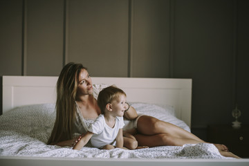 Wall Mural - Young mother with son in the bed