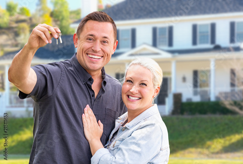 Fotografie, Obraz Young Adult Couple With House Keys In Front of Beautiful Home