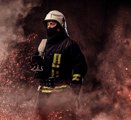 Wall Mural - A firefighter dressed in a uniform in a studio.