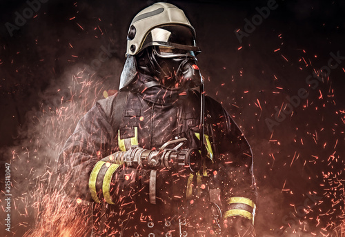 Fotomural A firefighter dressed in a uniform in a studio.