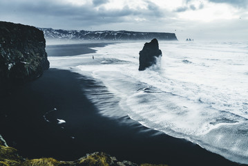 Wall Mural - sunrise at famous black sand beach reynisfjara in iceland. windy morning. ocean waves. colorful sky.