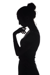 Wall Mural - silhouette profile of a sad woman with hand near chin on a white isolated background