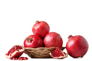 Wall Mural - Ripe and juicy pomegranate in basket on white background