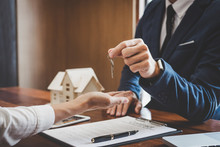 Real Estate Agent Sales Manager Holding Filing Keys To Customer After Signing Rental Lease Contract Of Sale Purchase Agreement, Concerning Mortgage Loan Offer For And House Insurance