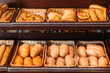 © LIGHTFIELD STUDIOS - freshly baked various bread in pastry department of grocery store