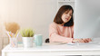 © Lifehdfilm - Young asian businesswoman using computer pc and smartphone at home office.