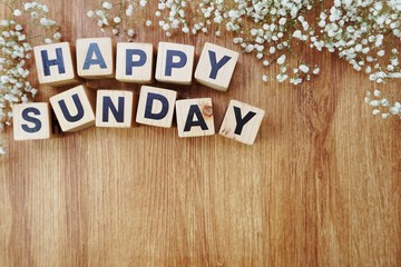 happy sunday alphabet letters on wooden background