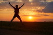 © Sergei Malkov - Silhouette of a young man jumping against the sunset with a sense of joy of happiness and freedom