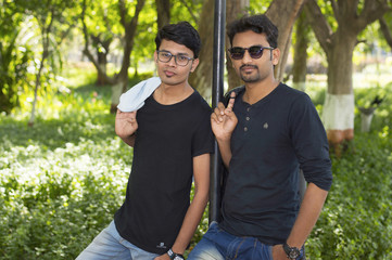 Two handsome young men in casual trendy clothes looking at camera