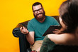 © Vulp - Bearded Man psychologist listening and smiling at his female patient on a couch.