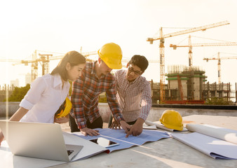 three construction engineers working together in construction site planning for the renovation