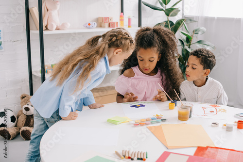 Fotografie, Obraz multiethnic preschoolers looking at african american classmate drawing picture a
