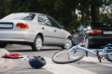 Wall Mural - Kid's bike and helmet on pedestrian crossing after collision with drunk car driver