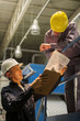 © PhotoAlto - Factory workers with clipboard in factory