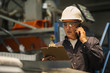 © PhotoAlto - Factory worker using mobile phone in factory