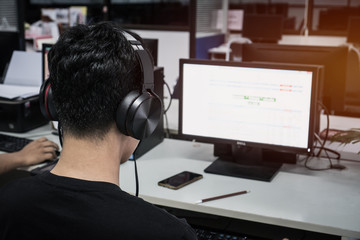Wall Mural - education e-learning foreign languages concept : asian student young man wearing headphones listenin